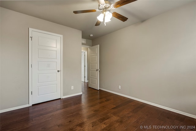 unfurnished bedroom featuring dark wood-type flooring and ceiling fan