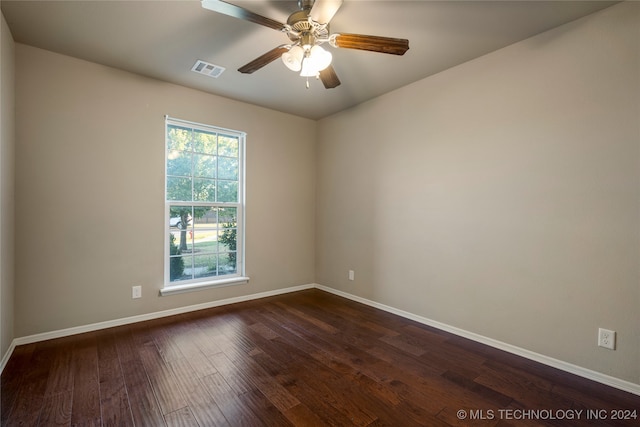 spare room with ceiling fan and dark hardwood / wood-style flooring