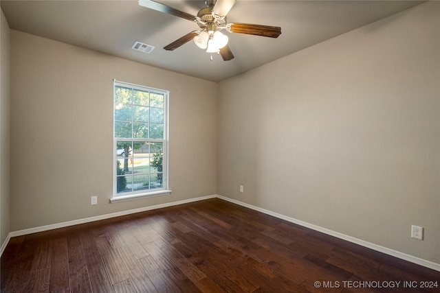 15410 E 87th St, Owasso, OK 74055 - unfurnished room with healthy amount of natural light, baseboards, and dark wood-type flooring