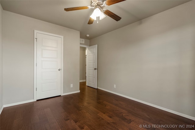 unfurnished bedroom featuring dark hardwood / wood-style floors and ceiling fan