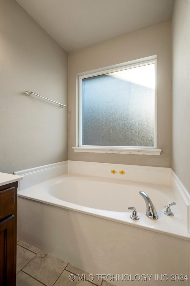 bathroom with vanity, a tub, and tile patterned flooring