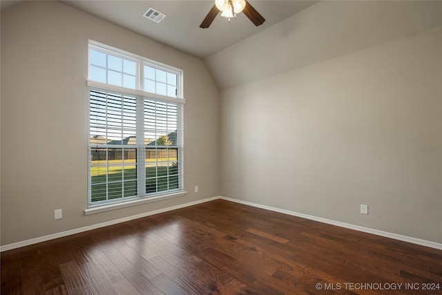 spare room featuring vaulted ceiling, dark hardwood / wood-style floors, and ceiling fan