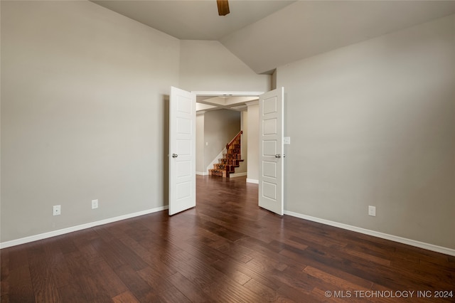 spare room with vaulted ceiling, dark hardwood / wood-style flooring, and ceiling fan