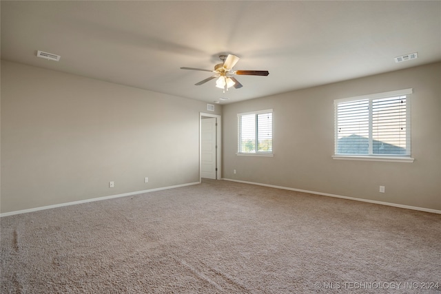 carpeted empty room featuring ceiling fan