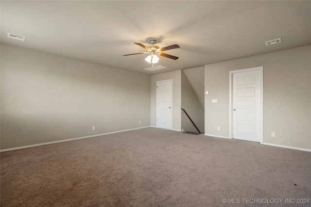 empty room featuring ceiling fan and carpet