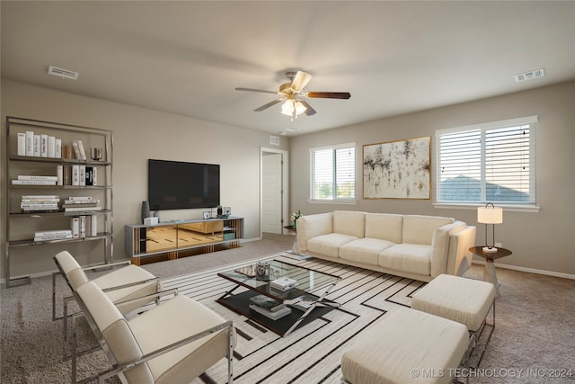 carpeted living room featuring ceiling fan