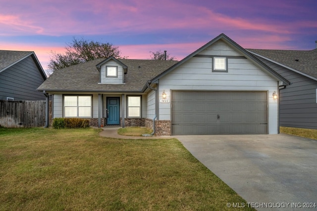 view of front of home with a lawn and a garage