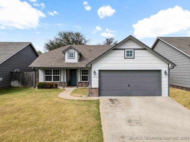 view of front of home featuring a front yard and a garage