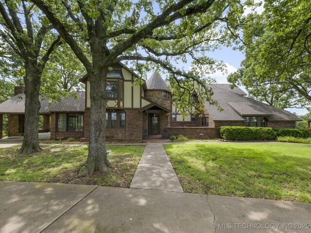 tudor home featuring a front yard