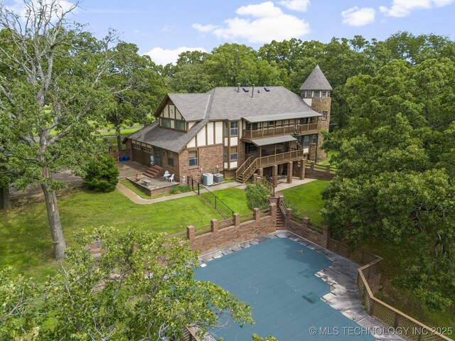 back of house with a patio, cooling unit, a yard, and a pool side deck