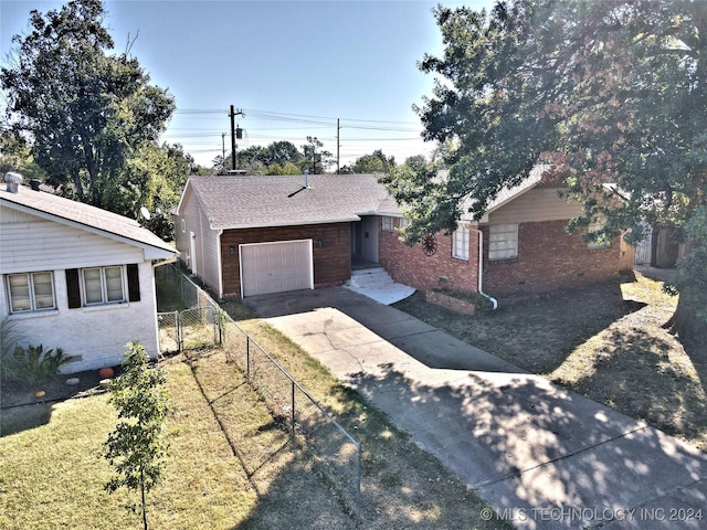 ranch-style house with a garage and a front lawn