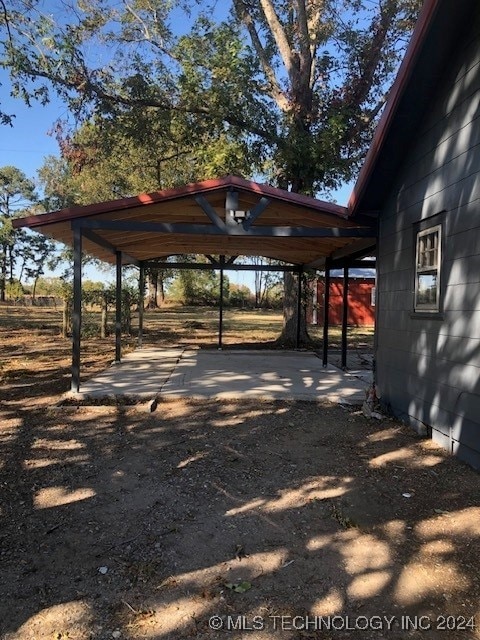 view of vehicle parking featuring a carport