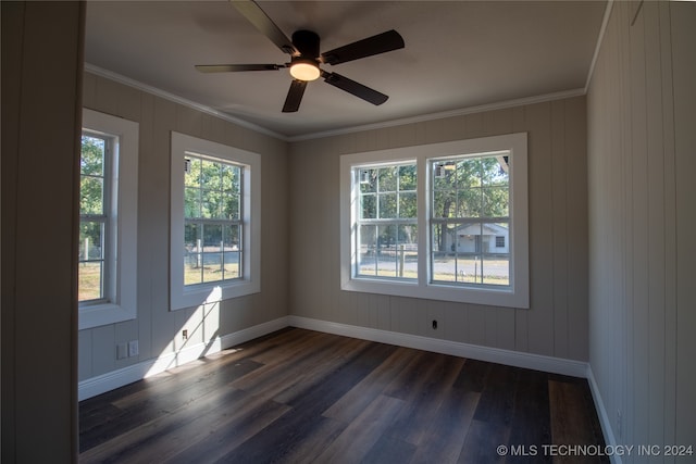 unfurnished room featuring crown molding, dark hardwood / wood-style floors, and ceiling fan