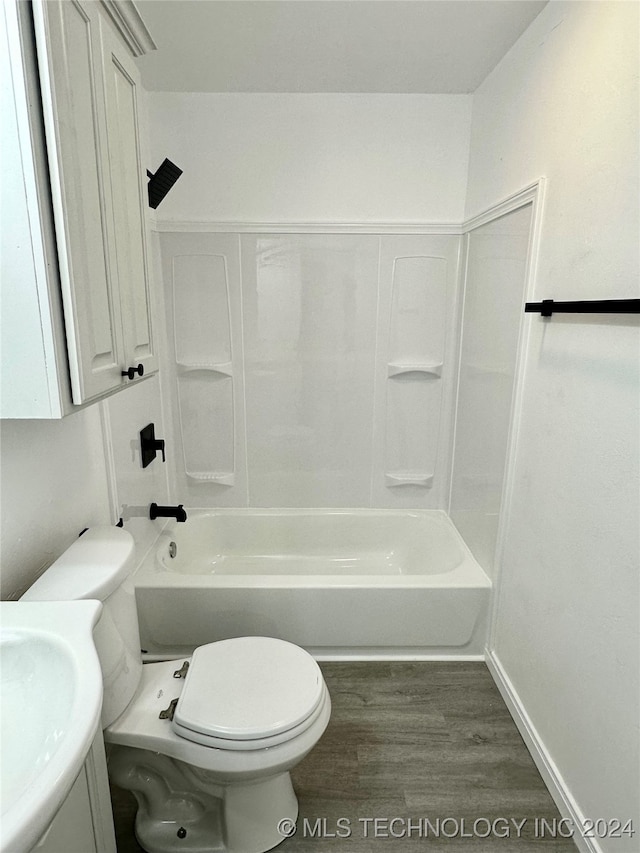 full bathroom featuring vanity, shower / tub combination, hardwood / wood-style flooring, and toilet