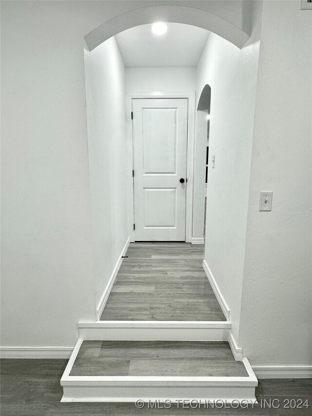 stairway with hardwood / wood-style flooring