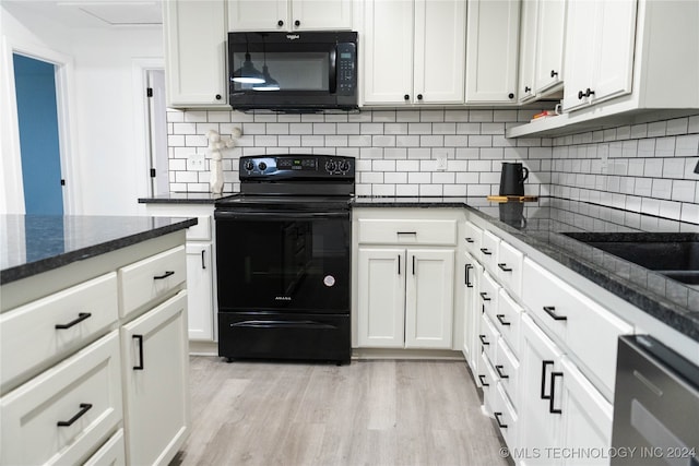 kitchen featuring light hardwood / wood-style flooring, backsplash, dark stone countertops, black appliances, and white cabinetry