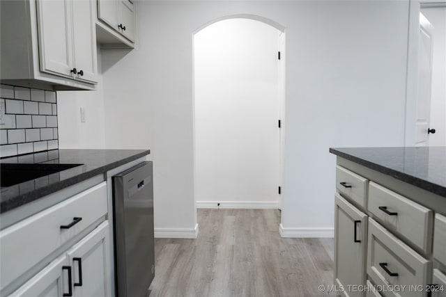 kitchen with light hardwood / wood-style floors, tasteful backsplash, and stainless steel dishwasher