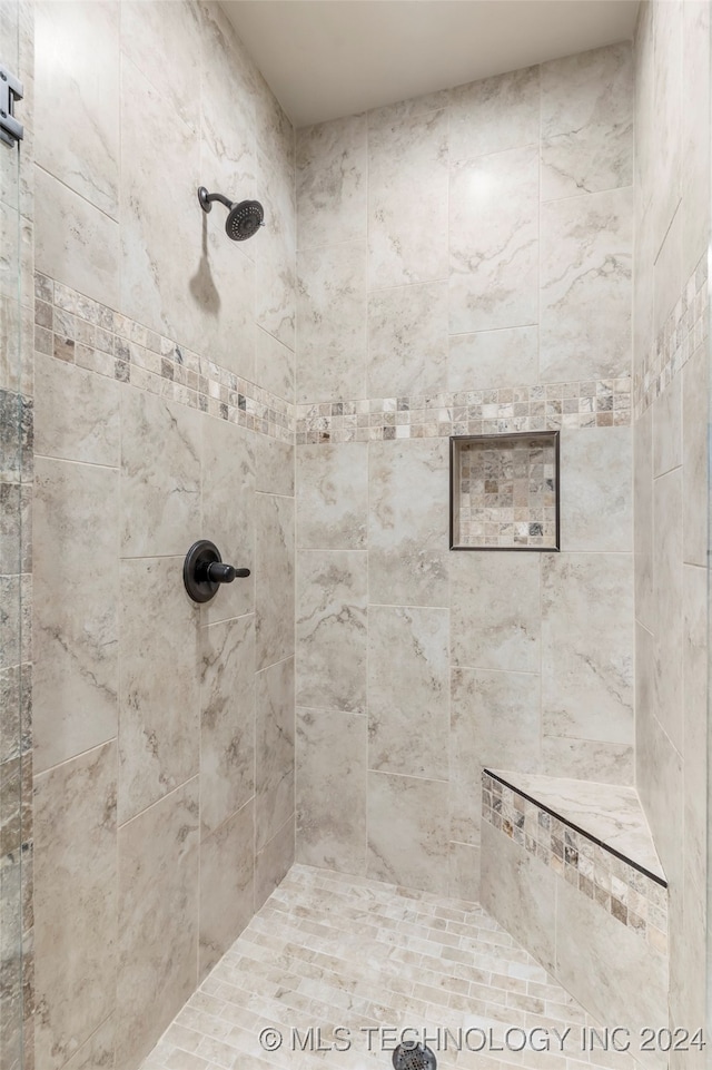 bathroom with a tile shower