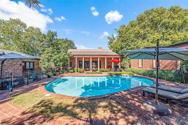 view of swimming pool with a patio