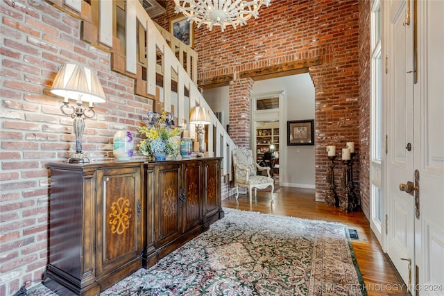 interior space featuring brick wall and wood-type flooring