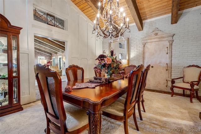 dining room featuring beam ceiling, brick wall, wooden ceiling, and light colored carpet