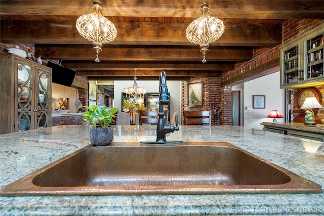 room details featuring beam ceiling, sink, a chandelier, and wooden ceiling