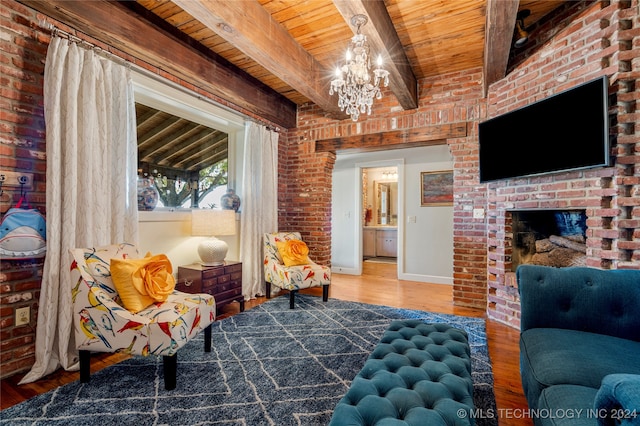 sitting room with wood ceiling, beam ceiling, wood-type flooring, a notable chandelier, and brick wall