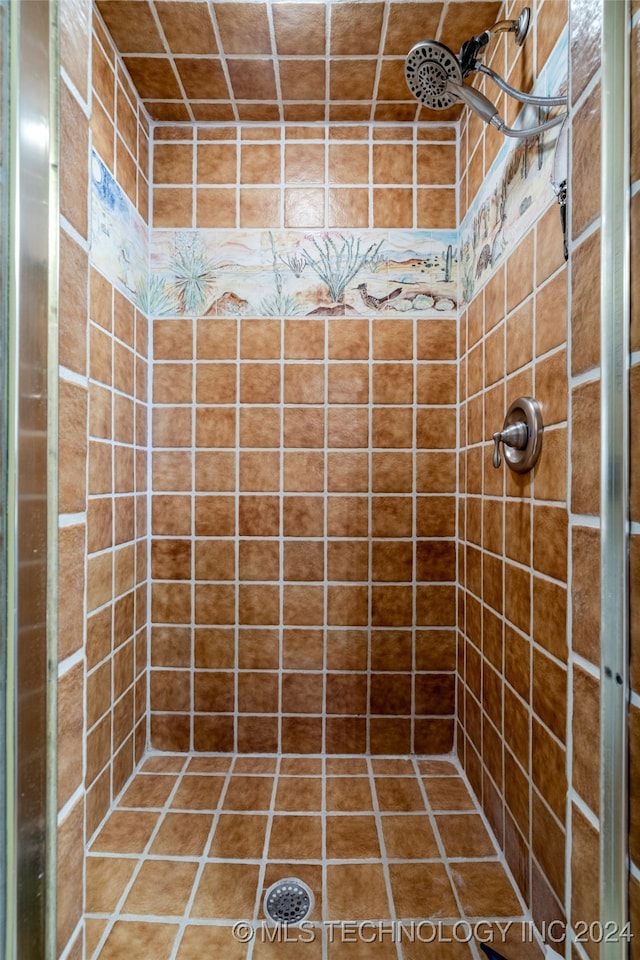 bathroom with tiled shower