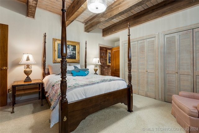 bedroom featuring wood ceiling, carpet floors, two closets, and beamed ceiling