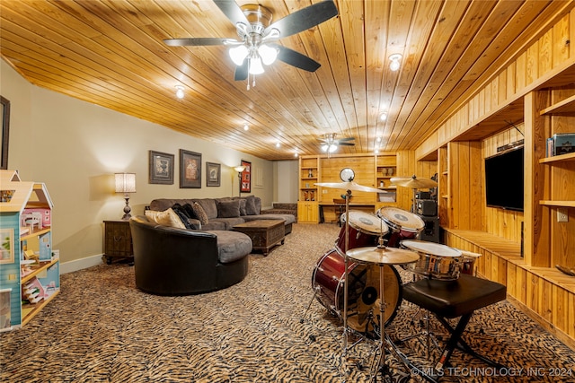 carpeted living room featuring wood ceiling, wooden walls, built in features, and ceiling fan