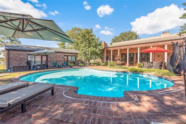 view of swimming pool with a patio