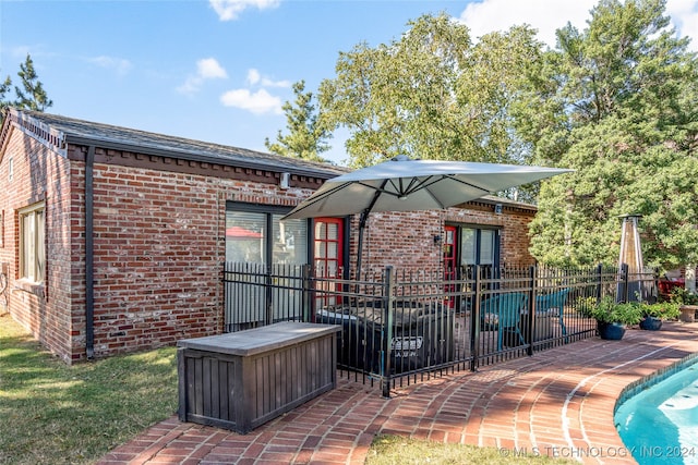 back of house with a patio area and a fenced in pool