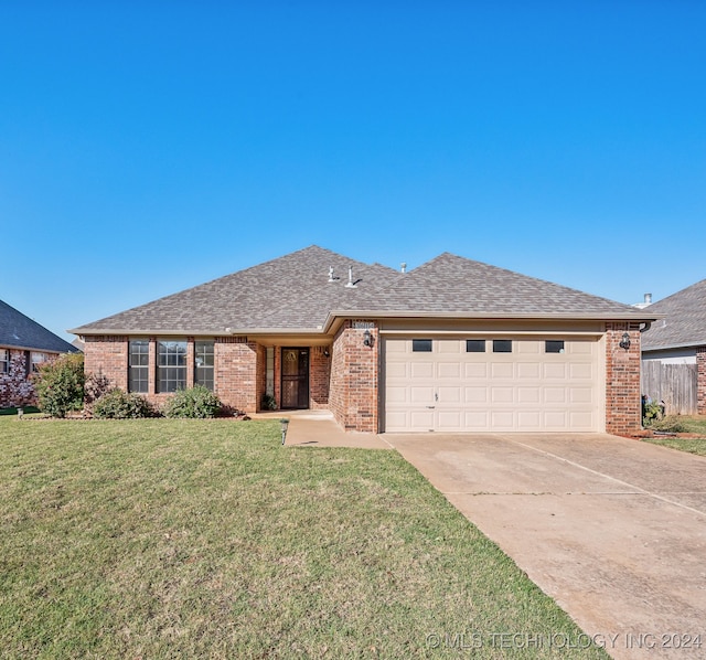 single story home with a front yard and a garage