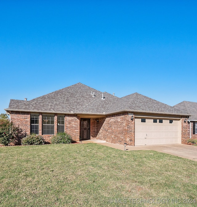 ranch-style home featuring a garage and a front lawn