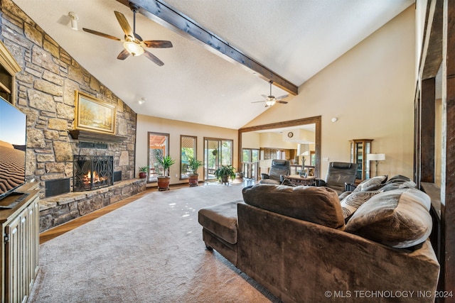 living room with high vaulted ceiling, ceiling fan, a fireplace, a textured ceiling, and beamed ceiling