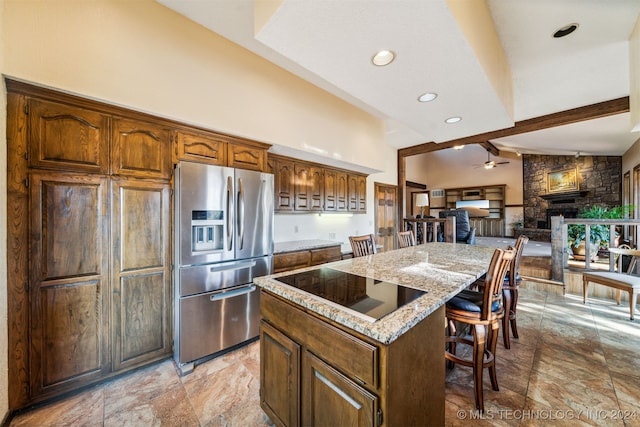 kitchen featuring a kitchen breakfast bar, vaulted ceiling with beams, stainless steel fridge, black electric stovetop, and a kitchen island