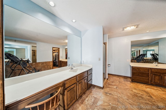 bathroom with vanity and a textured ceiling