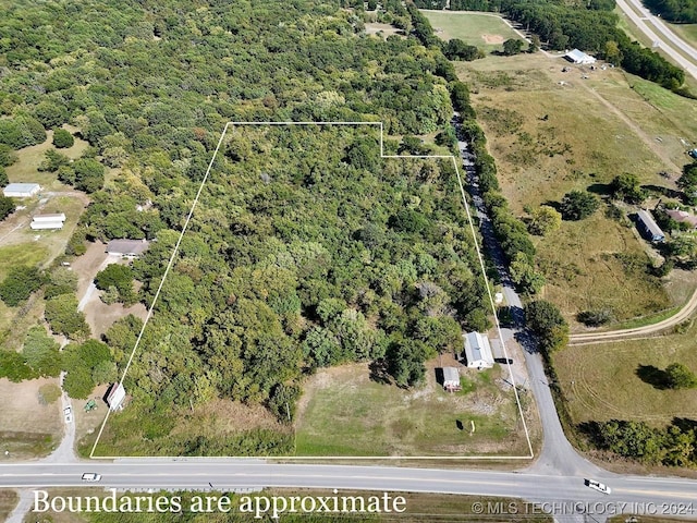 bird's eye view with a wooded view