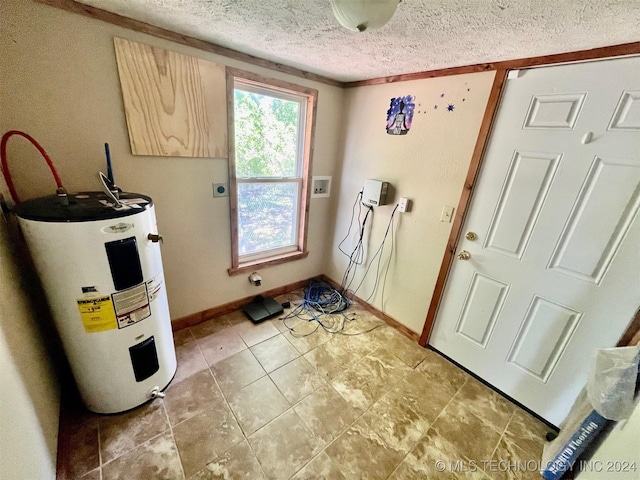 interior space featuring washer hookup, laundry area, baseboards, a textured ceiling, and electric water heater