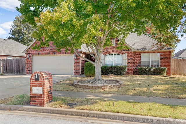 view of front of house with a front yard and a garage