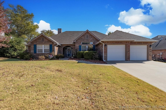 ranch-style home with a front yard and a garage