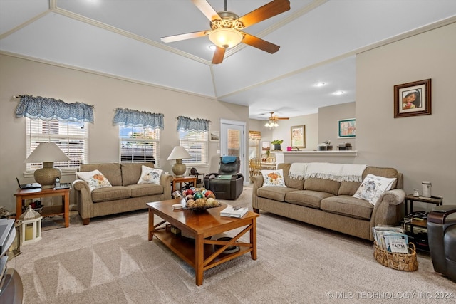 living room with light carpet, ornamental molding, vaulted ceiling, and ceiling fan