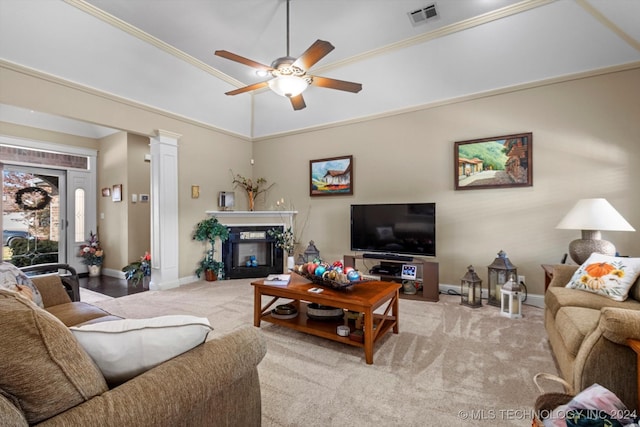 living room with ornamental molding, a high end fireplace, light colored carpet, and ceiling fan