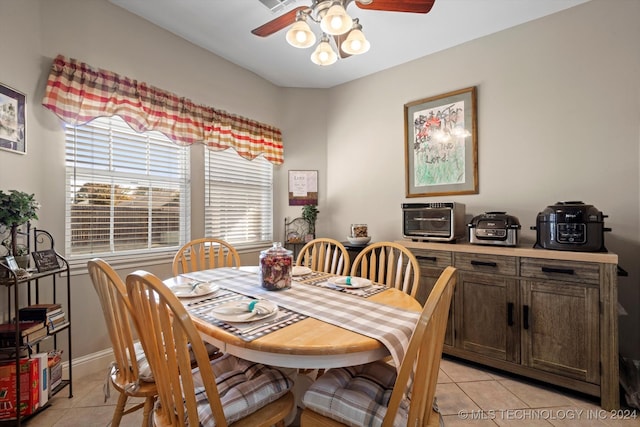 dining area with ceiling fan and light tile patterned floors