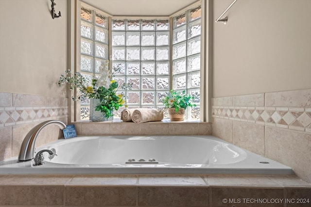 bathroom with tiled bath