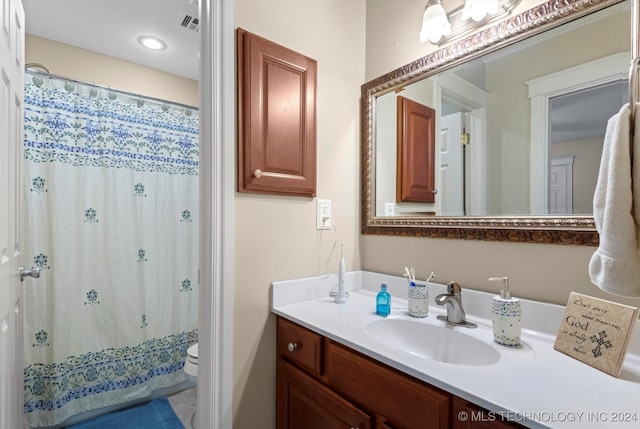 bathroom with vanity, toilet, and a shower with curtain