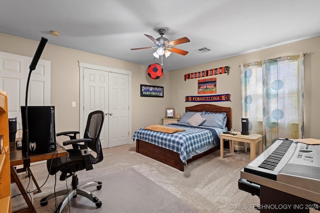 carpeted bedroom with a closet and ceiling fan