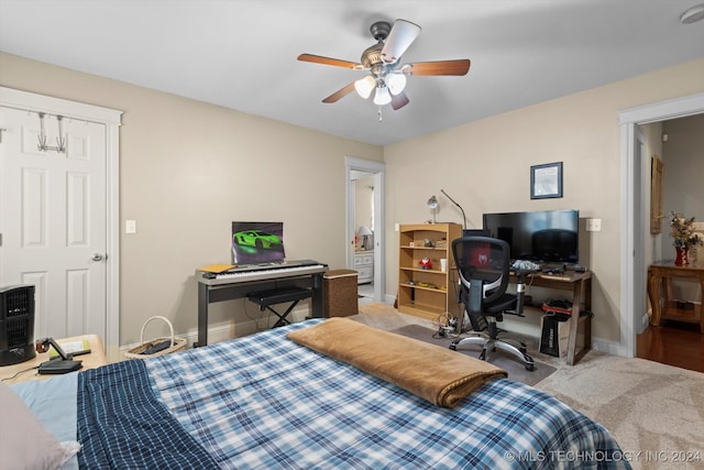 bedroom featuring ceiling fan and light colored carpet