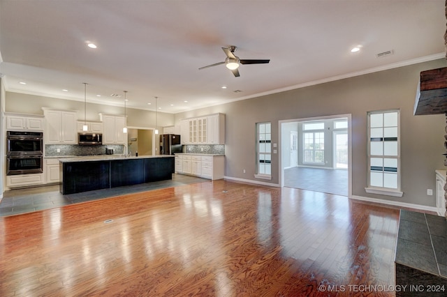 unfurnished living room with crown molding, wood-type flooring, and ceiling fan