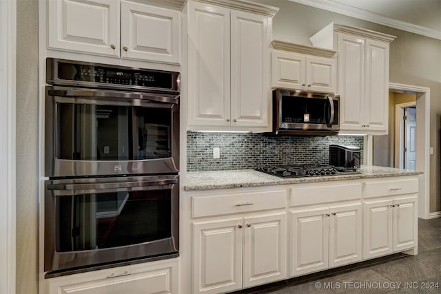 kitchen with ornamental molding, light stone countertops, stainless steel appliances, and tasteful backsplash